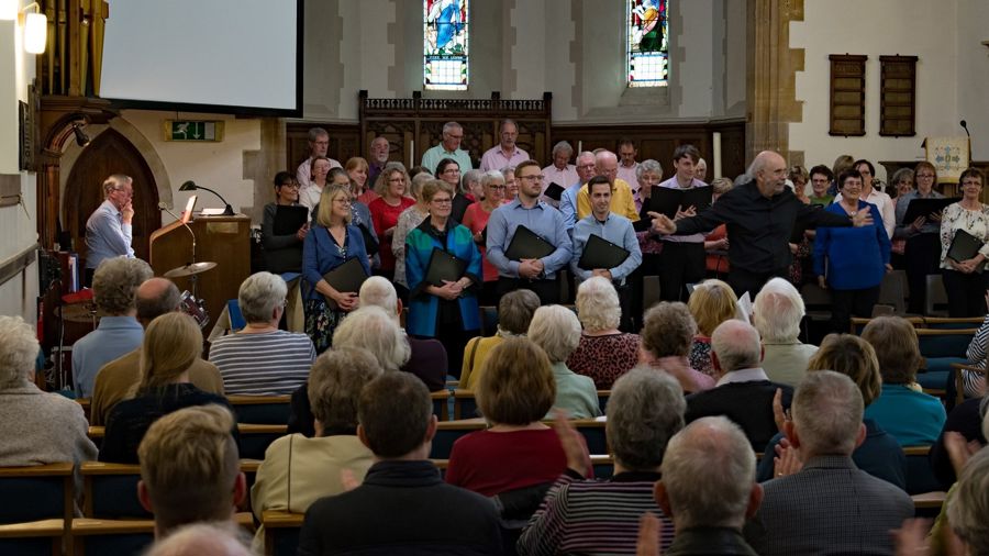 A choir and musicians performing before an audience in a church
