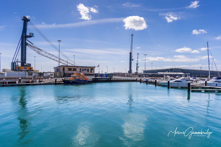 Yachts, a lifeboat and harbour scene.