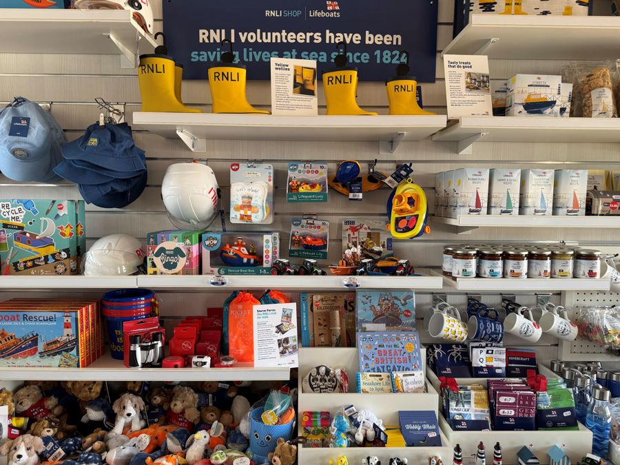 Shelves stocked with RNLI branded gifts and toys