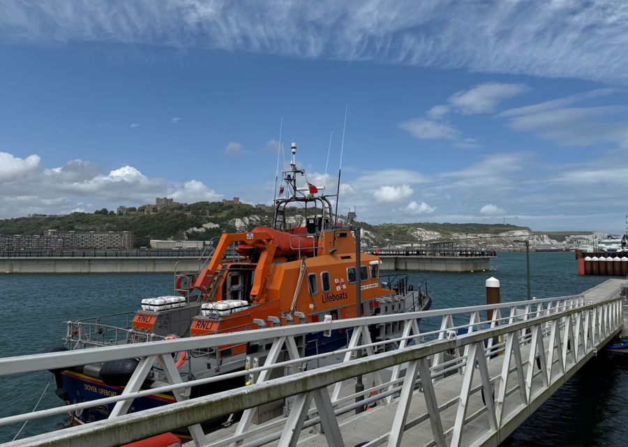 Orange and blue lifeboat with blue sky overhead