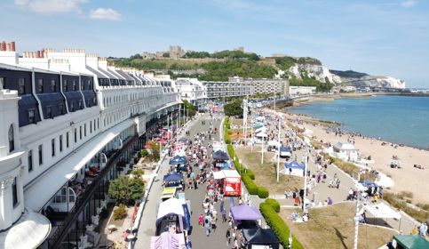 An aerial view of Dover Regatta, Dover seafront and the castle and cliffs in the background.