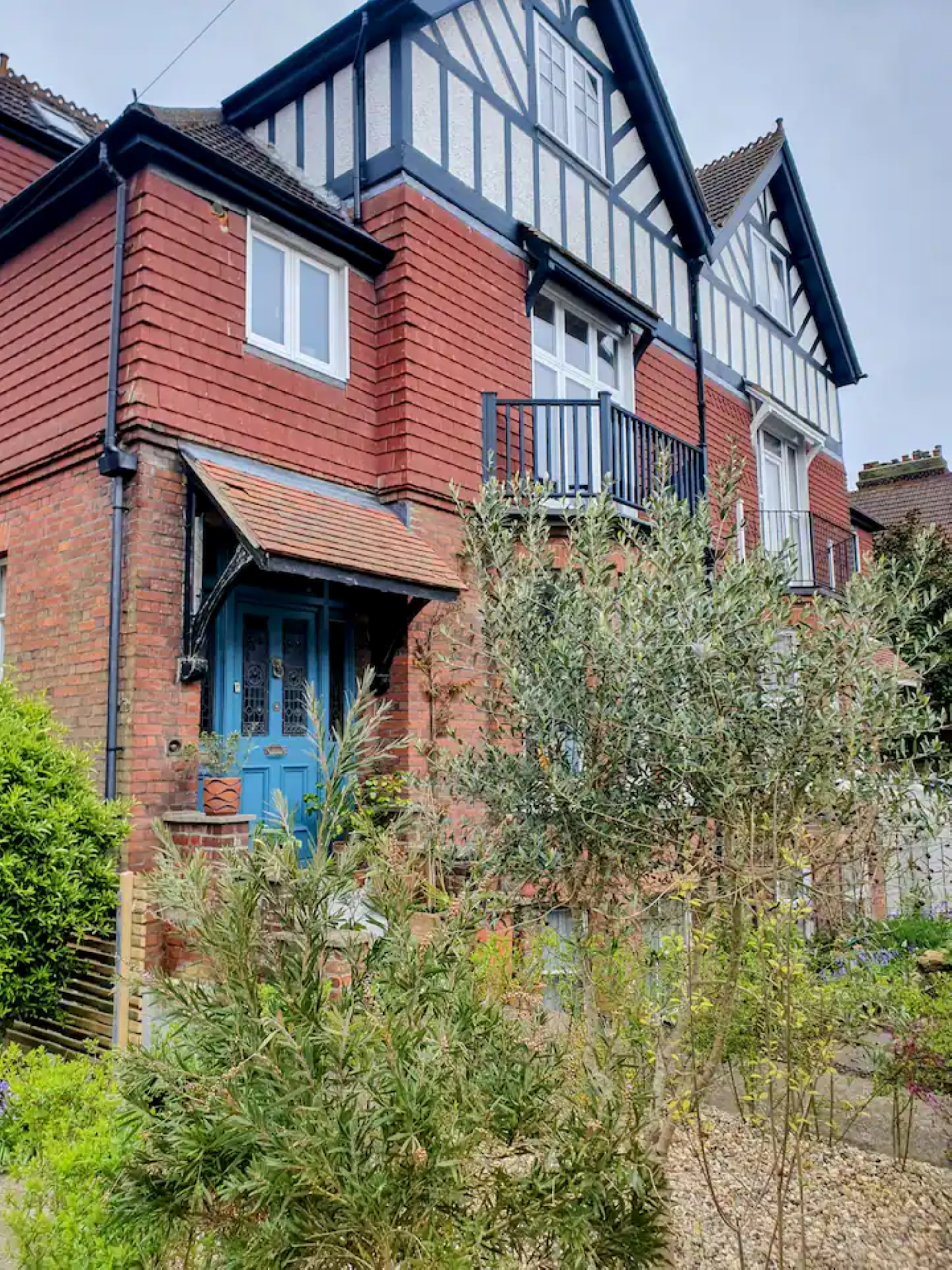 The front view of The Dover Stop, a Victorian house with a blue period door.