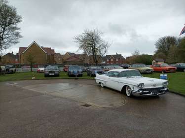 A variety of classic cars displayed in the museum grounds