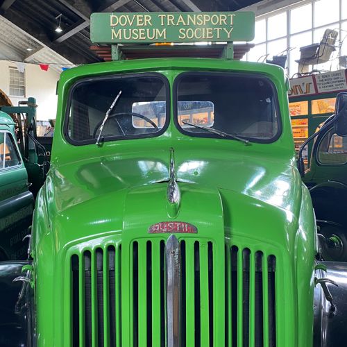 A green vintage truck with sign saying Dover Transport Museum Society