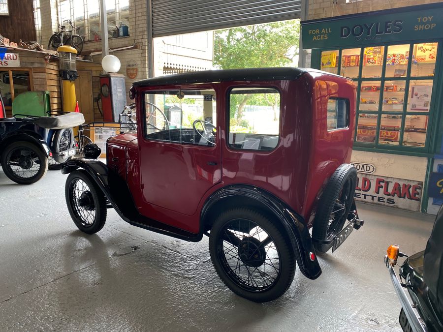A classic red car on display at the museum