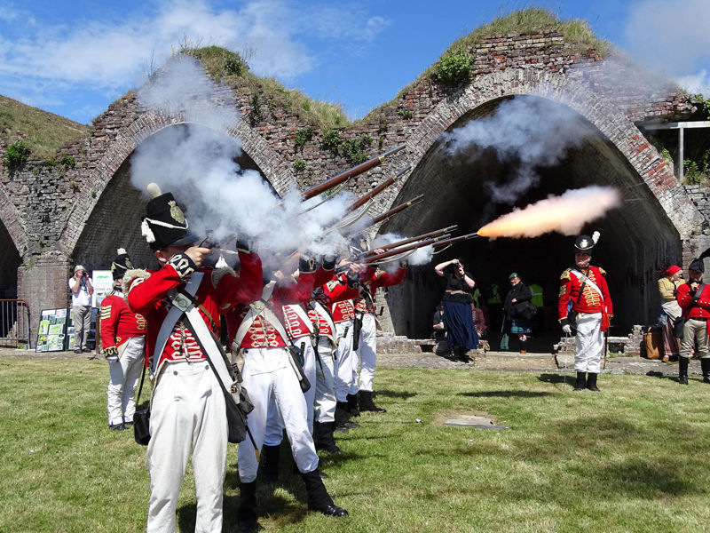 A group of Napoleonic War re-enactors firing muskets