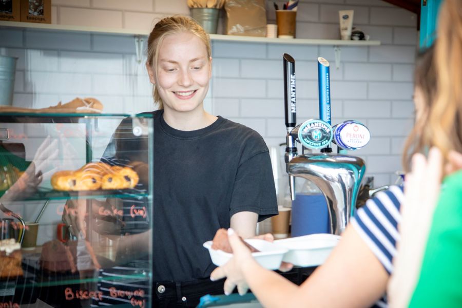 A barrister serving someone a slice of cake.