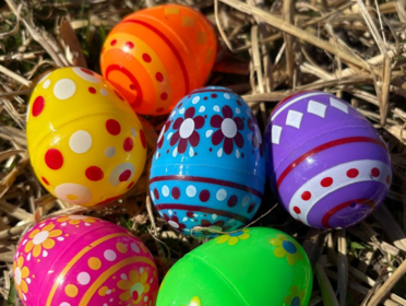 Plastic decorated easter eggs on straw