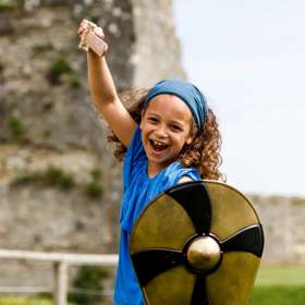 Image of a young girl holding a shield and a sword 