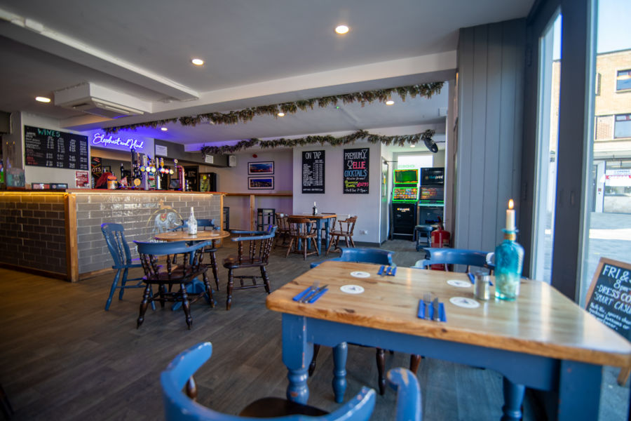 Interior of Elephant & Hind showing bar and tables and chairs.