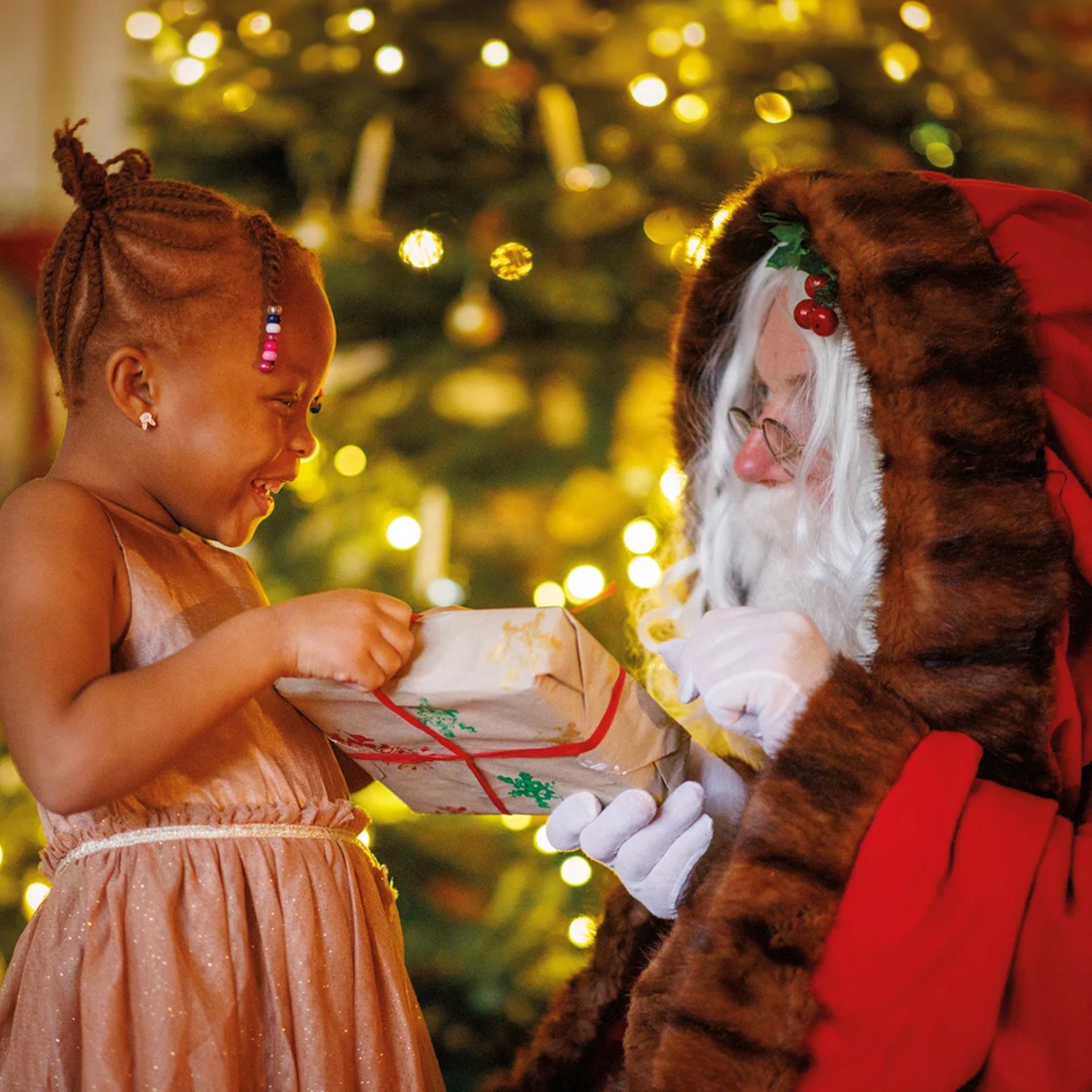Father Christmas giving a present to a little girl