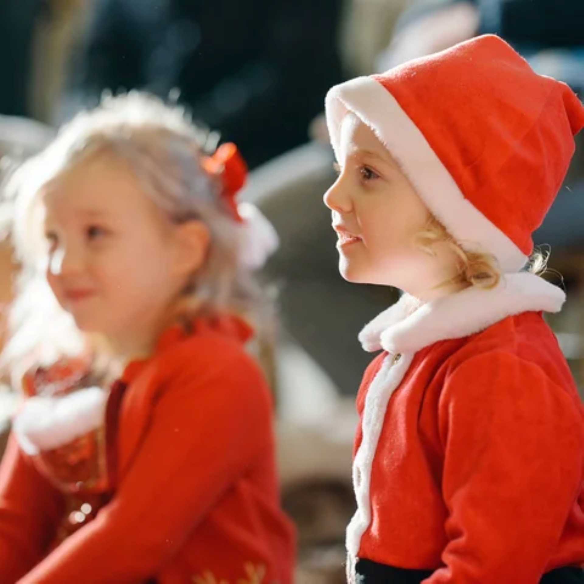 2 little girls dressed in red and white