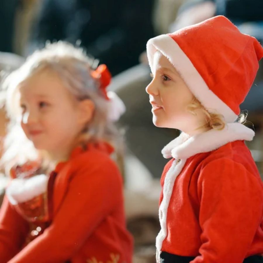 2 little girls dressed in red and white