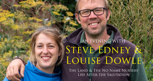 Two people in front of a variety of plants