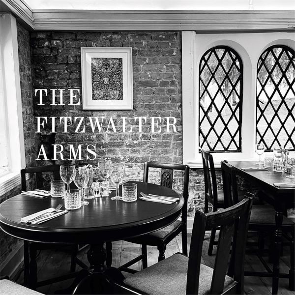 Black & white photo of a dining table laid out for dinner