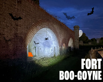Fort Burgoyne at twilight with cartoon ghost, spider, bats and pumpkins
