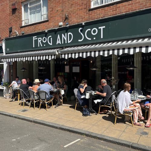 Customers sitting eating and drinking outside The Frog and Scot