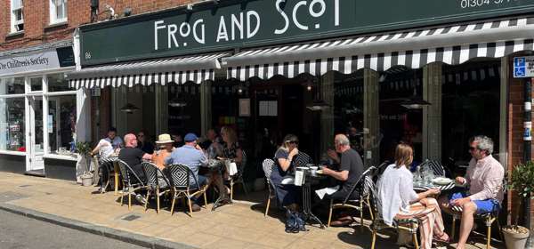 Customers sitting eating and drinking outside The Frog and Scot