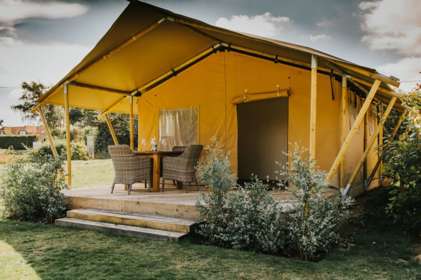 Safari tent with outside deck and table and chairs
