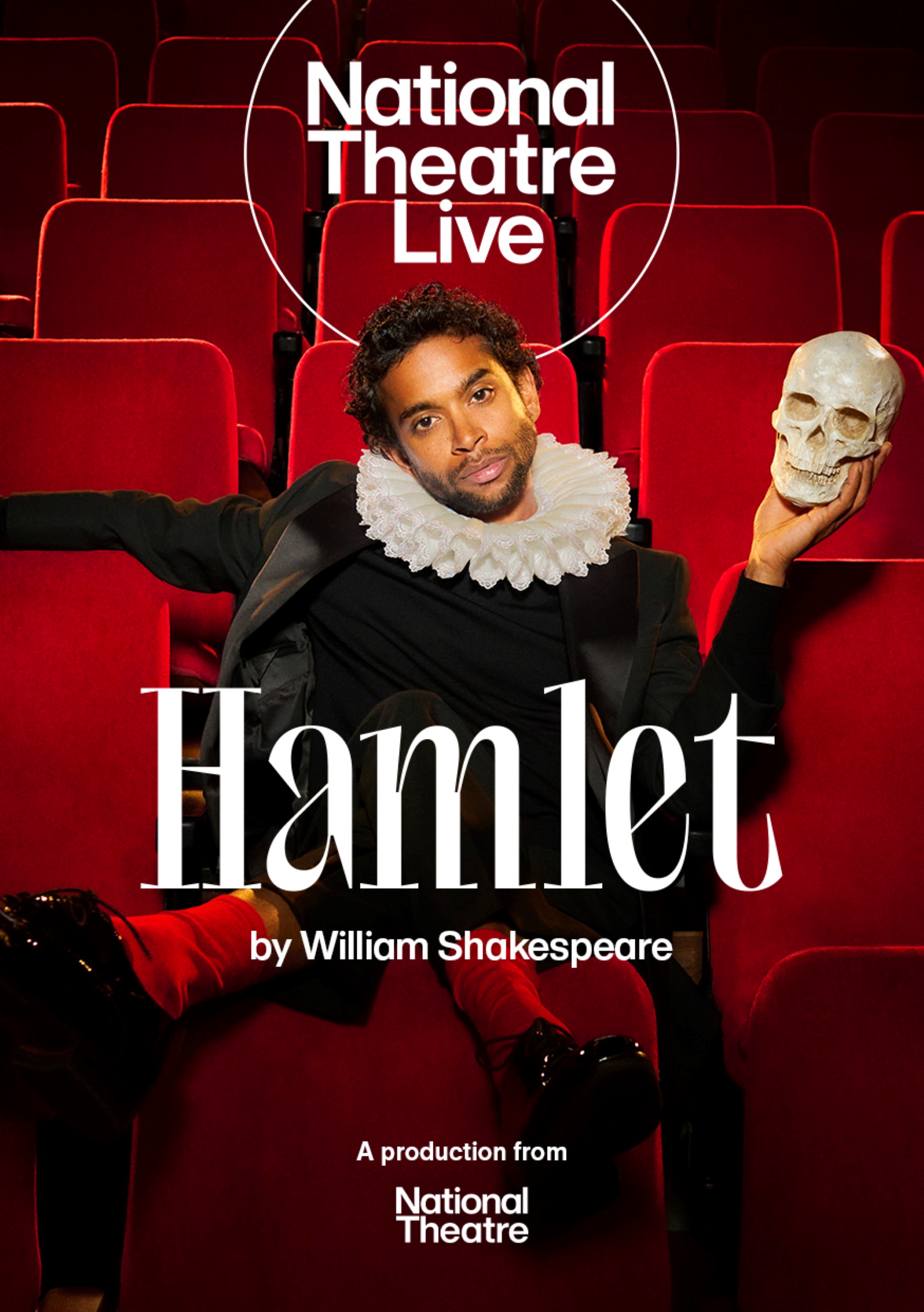 Actor dressed as hamlet holding a skull
