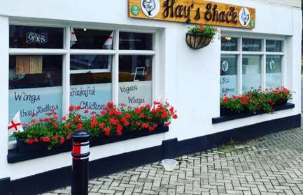 Exterior of Hay's Shack with geranium filled window boxes