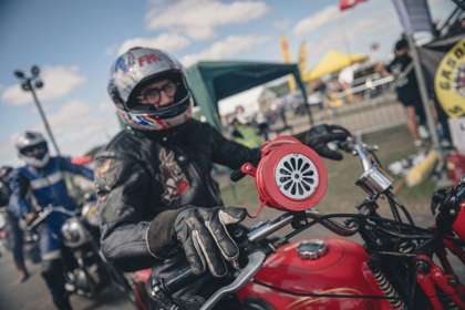 A man in leathers on a red motorbike