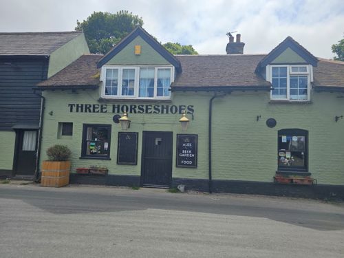 The exterior of the green Three Horseshoes