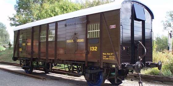 A dark brown wooden railway van