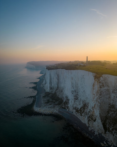 White Cliffs at dusk with the Dover Patrol Monument in silhouette 