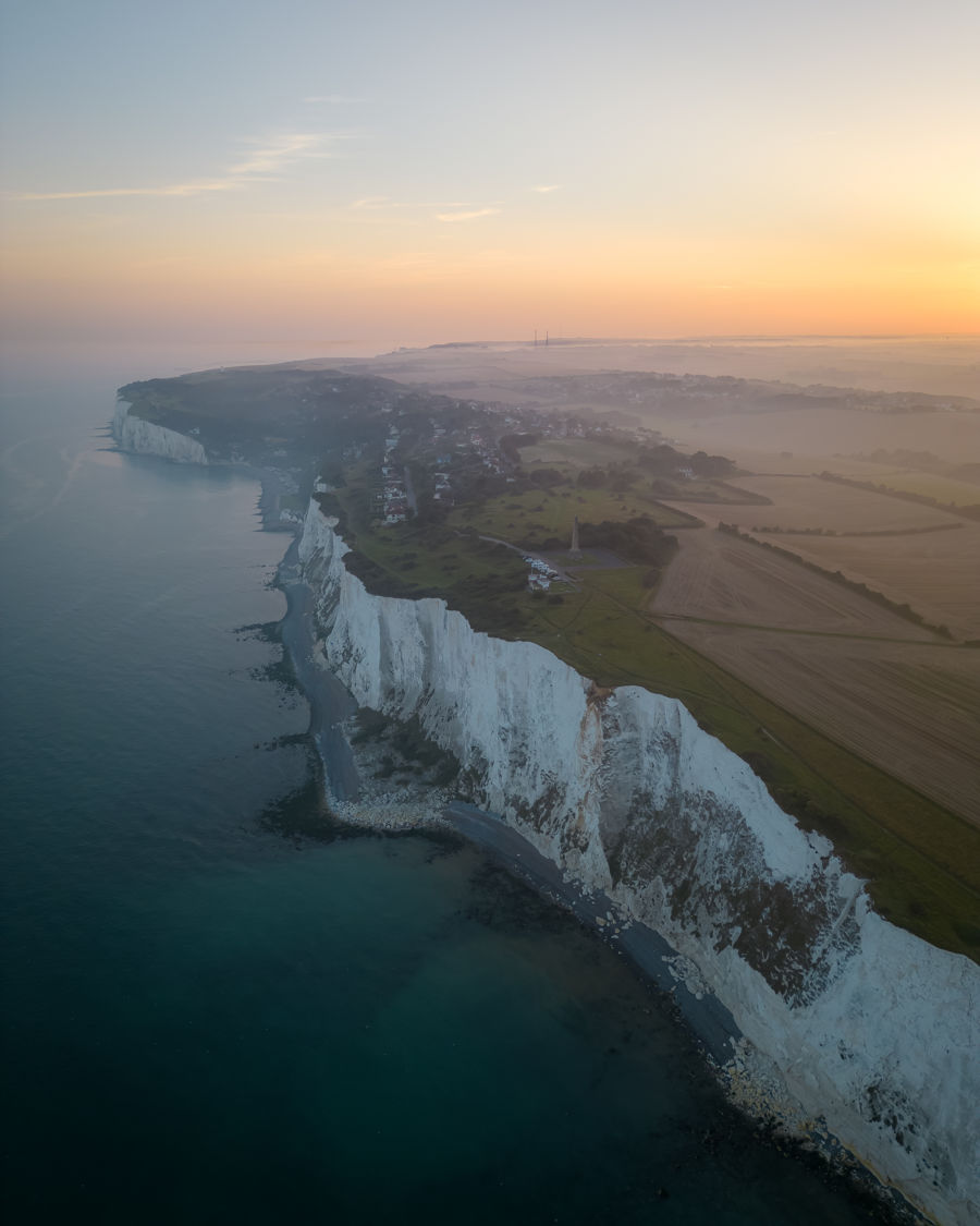 An aerial shot of the White Cliffs, St Margaret's Bay, sea and countryside at sunset.