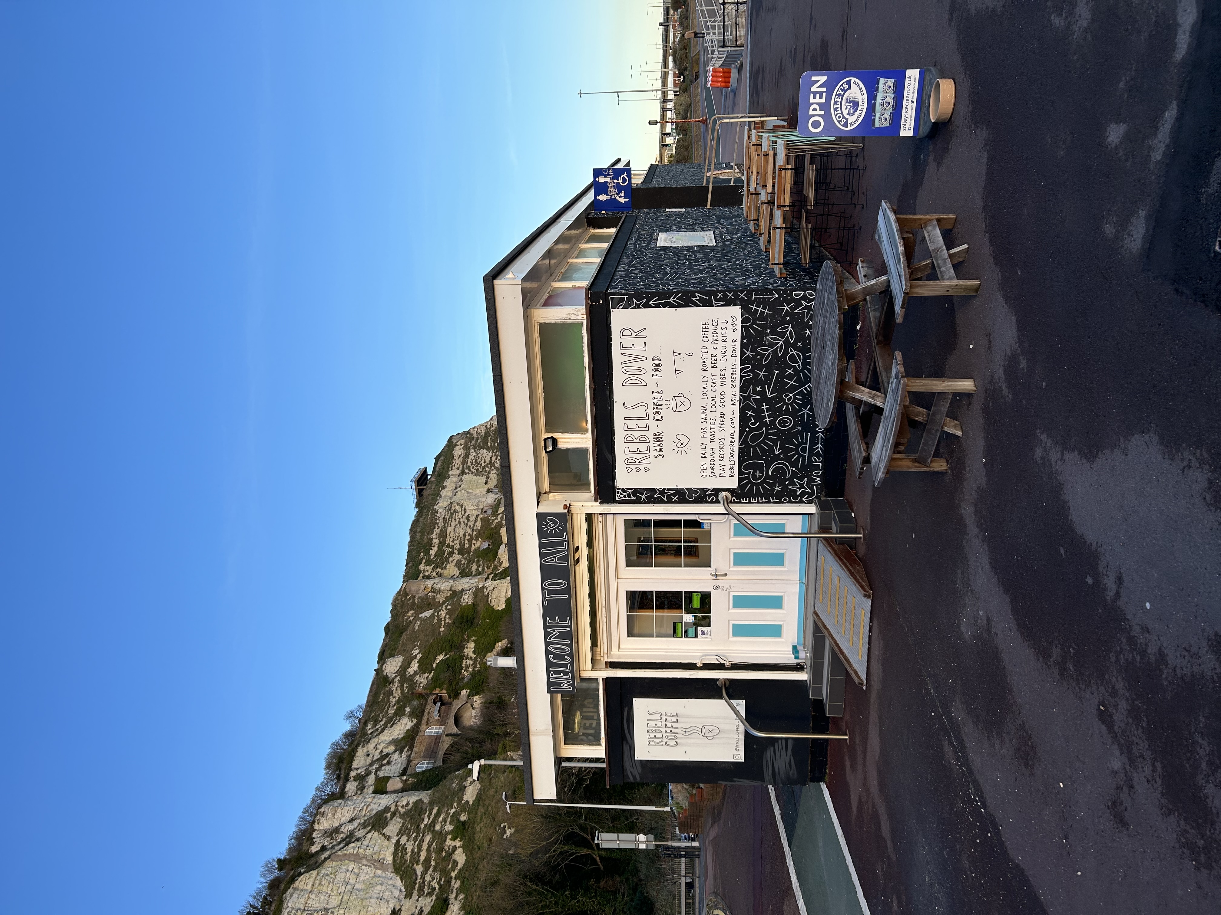 The exterior of Rebels Dover, a cafe and sauna, with the White Cliffs behind.