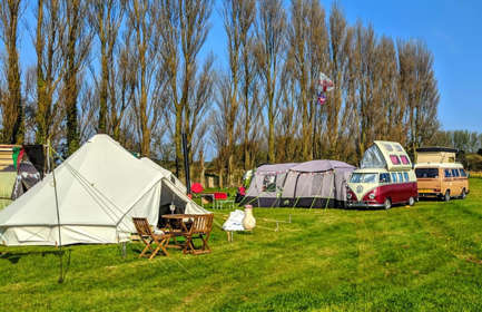 Lillyroo's camp site showing a bell tent with outside table & chairs and two VW camper vans.