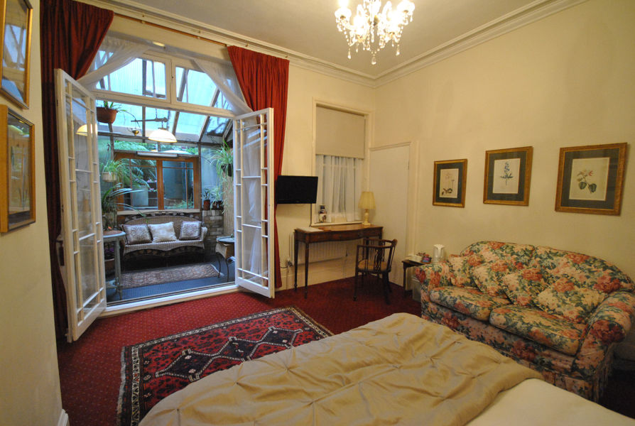 View through French doors to covered seating area