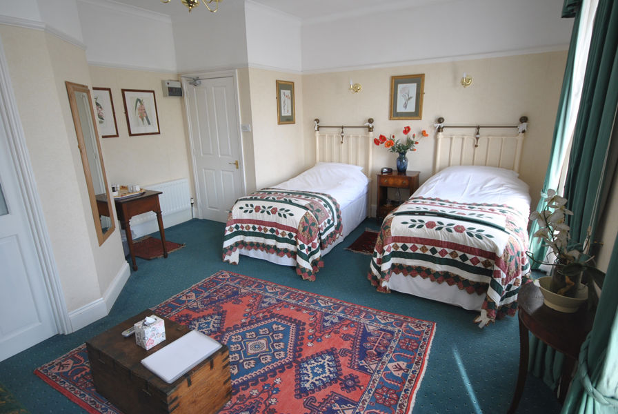 Twin bed room with antique brass beds