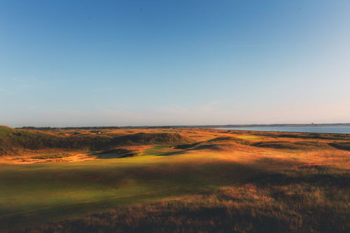 Golf course with sea in the distance