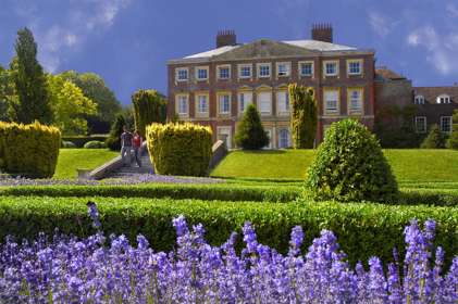 Goodnestone Park manor house with topiaried hedge and lavender bushes in the foreground