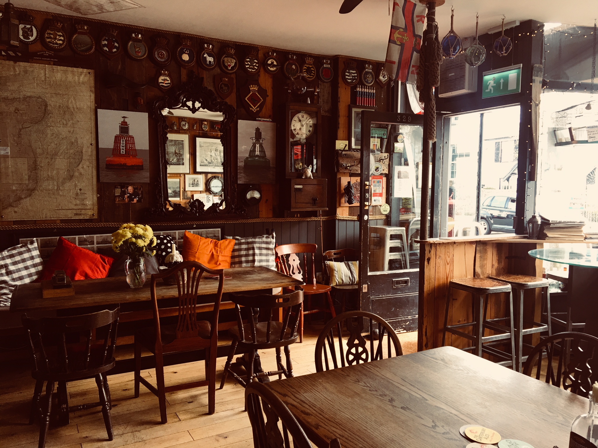 Wooden panelled interior of a bar with wooden furniture.