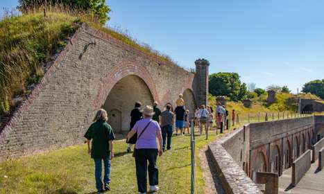 A group walking around the upper level of a military fort