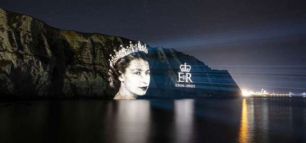 An image of HM Queen Elizabeth II projected onto the White Cliffs of Dover