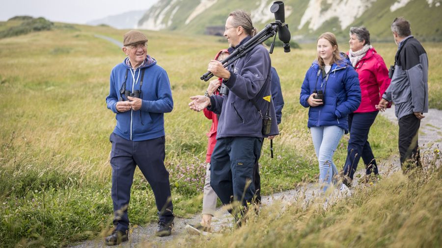 Warden and group walking along a path talking