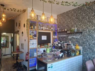 The counter of a cafe with cakes on display