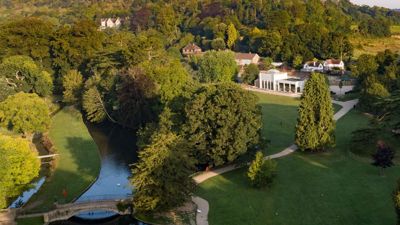 Aerial view showing the parkland, lake and cafe at Kearsney Abbey