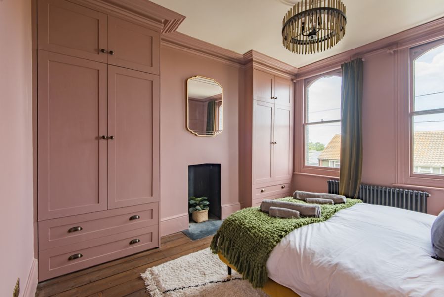 Double bedroom with built in wardrobes in pale pink