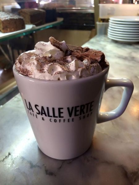 Cup of something hot smothered in cream and chocolate