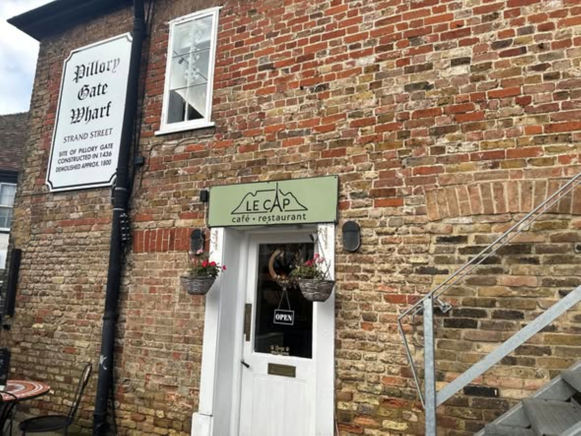 White front entrance door with hanging baskets