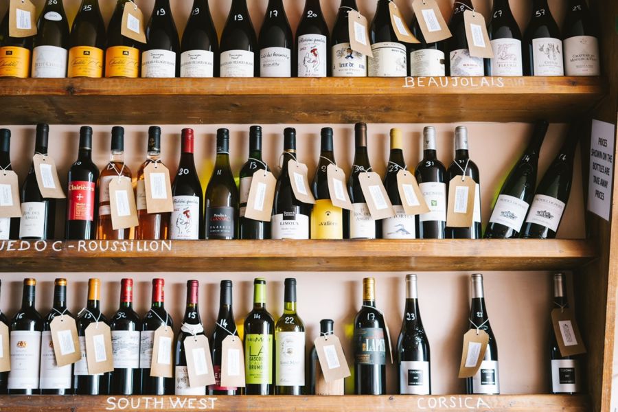 Wooden display shelves showing a vast selection of different wines.