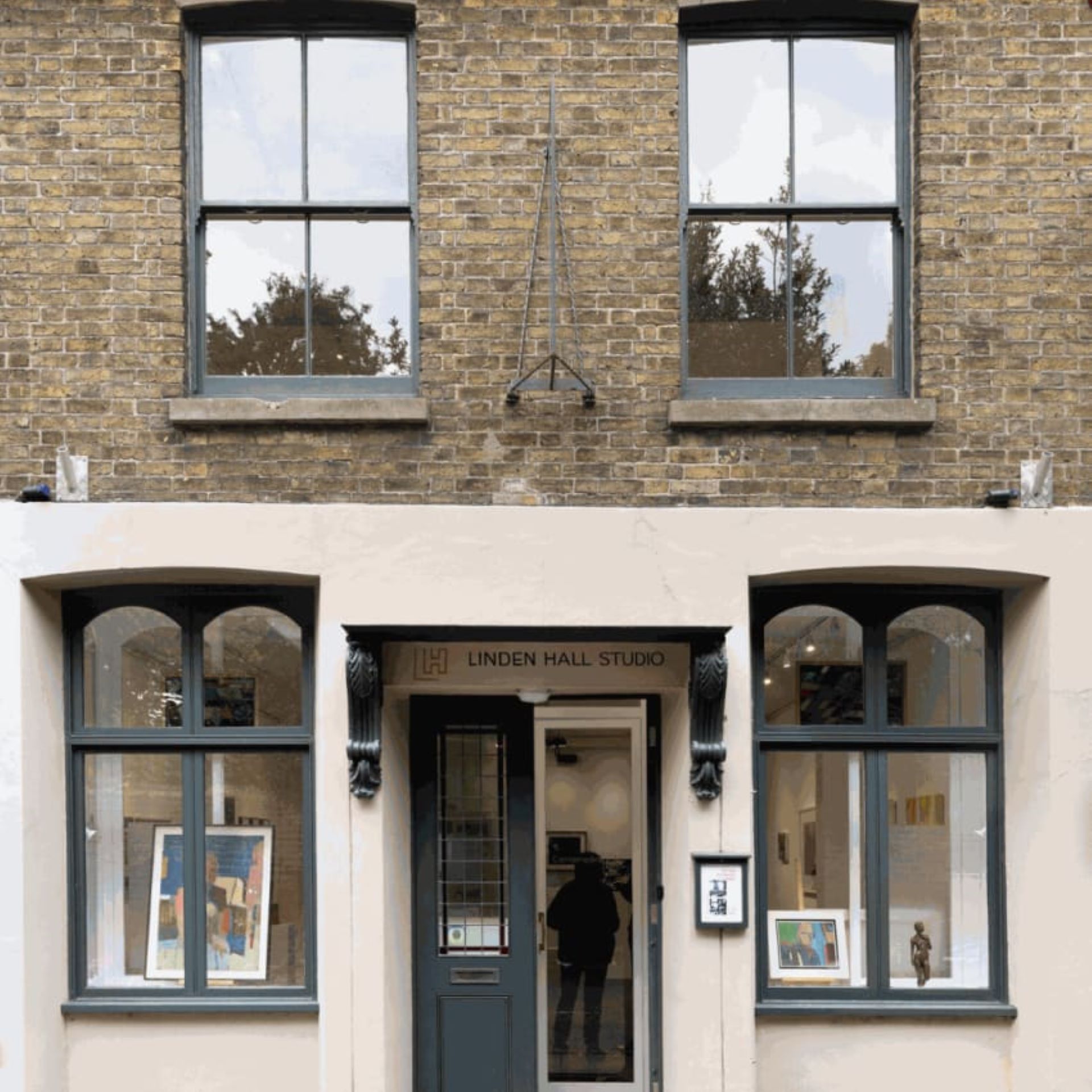 The frontage of a building with four windows and a door with the words Linden Hall Studio above.