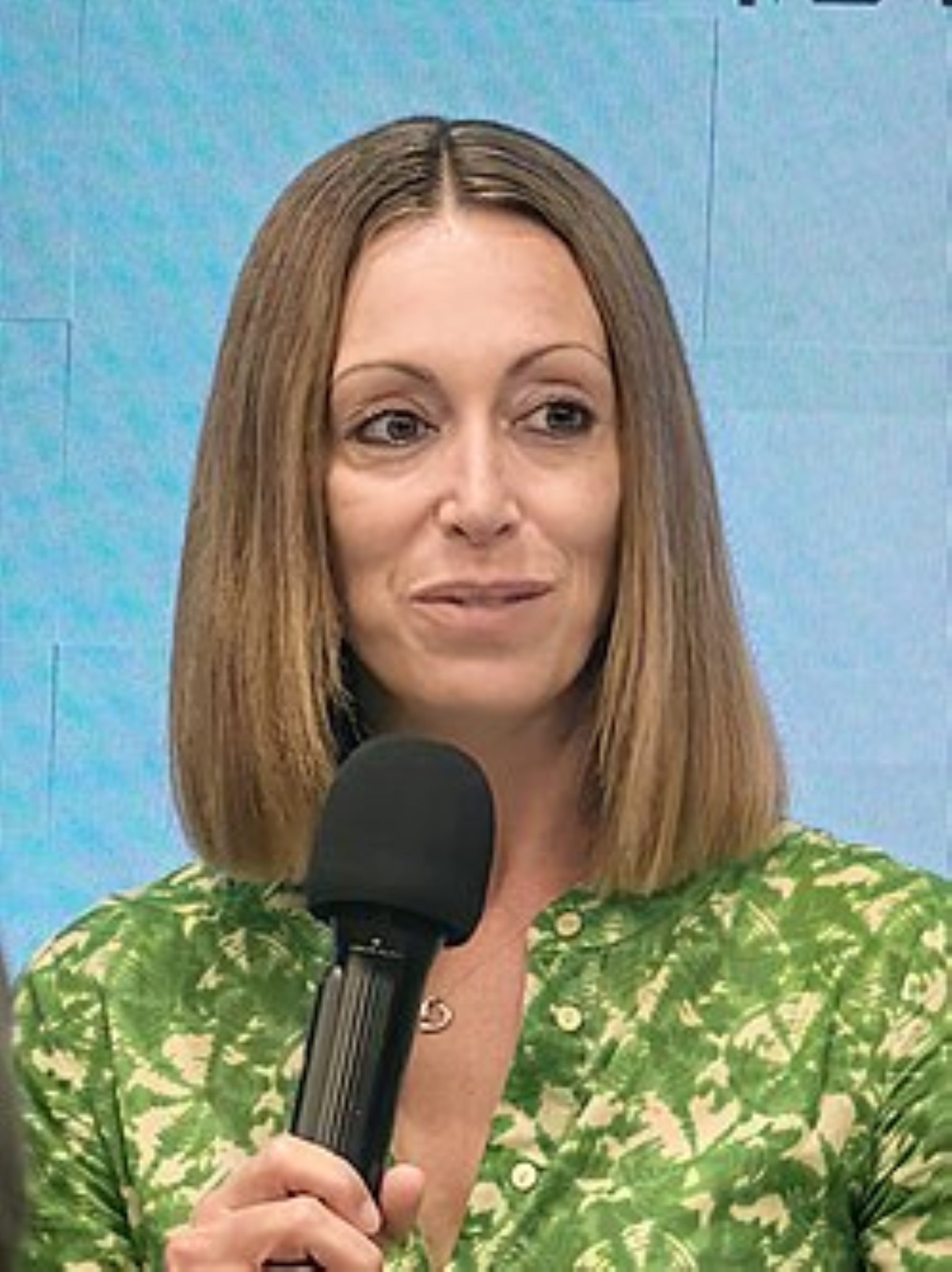 A woman the author Lucy Caldwell holding a microphone