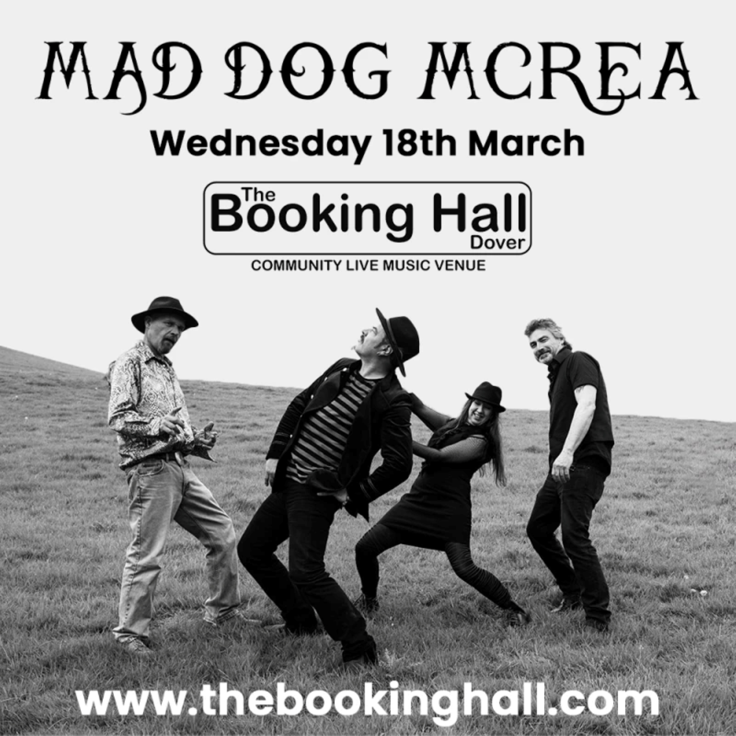 Black & white photo of 3 men and a woman posing on a grassy hill. A music band called Mad Dog Mcrea.