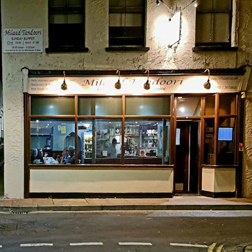View of the Milaad Tandoori frontage at night